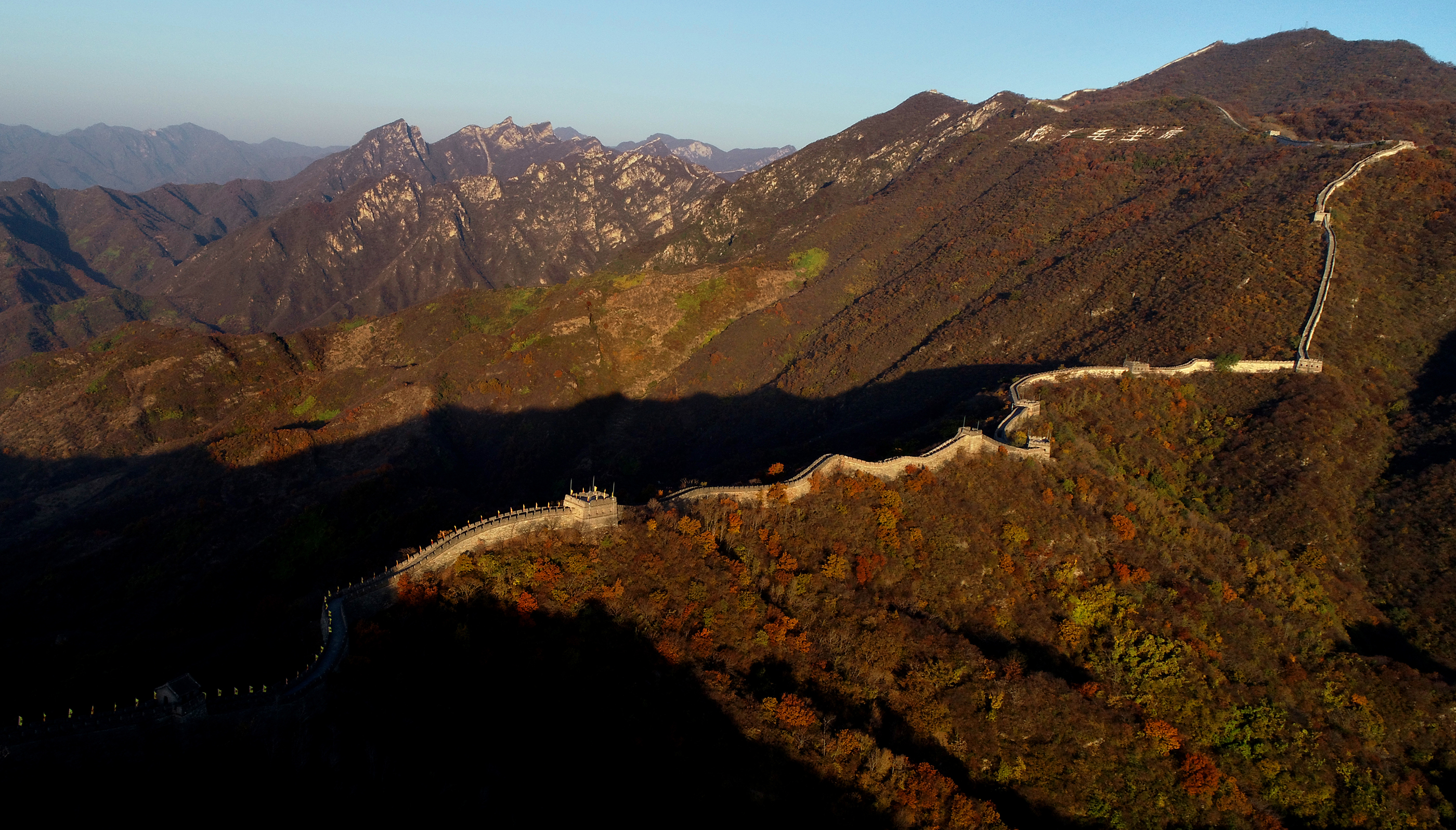 The Great Wall winding across mountains in autumn